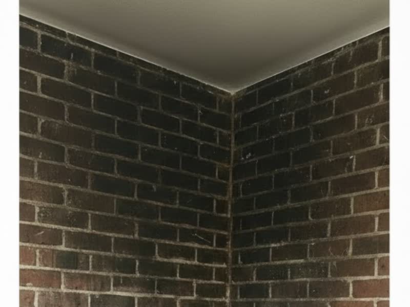 Brick corner with smoke staining before laser cleaning